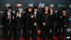 Members of South Korea boy group BTS pose for the photographers on the red carpet of the 2015 Mnet Asian Music Awards (MAMA) in Hong Kong, Wednesday, Dec. 2, 2015. (AP Photo/Kin Cheung)