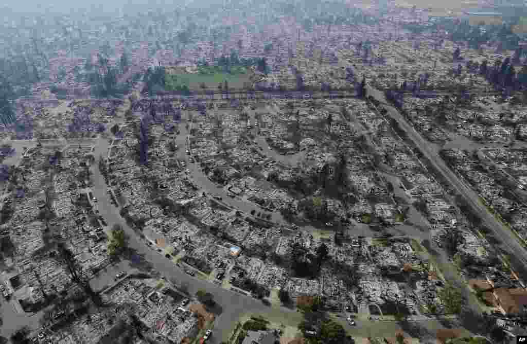 Homes burned by a wildfire are seen in Santa Rosa, California, Oct. 11, 2017. Wildfires whipped by powerful winds swept through Northern California sending residents fleeing for safety through smoke and flames as their homes burned.