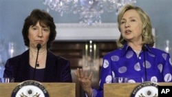 European Union High Representative Catherine Ashton listens at left as Secretary of State Hillary Rodham Clinton, speaks to the media at the State Department in Washington, Monday, July 11, 2011. (AP Photo/Jacquelyn Martin)