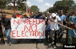 Supporters of Kenyan opposition National Super Alliance (NASA) coalition carry a banner as they demonstrate in Nairobi, Kenya, Oct. 11, 2017.