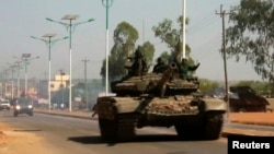A military tank patrols along one of the main roads in the South Sudanese capital Juba, Dec. 16, 2013.
