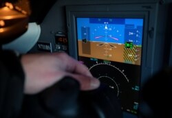 Robert Bryan, chief pilot at Eagle Aviation, points to a displayed altimeter reading while discussing the effect that new 5G wireless services can have on sensitive airplane electronics.