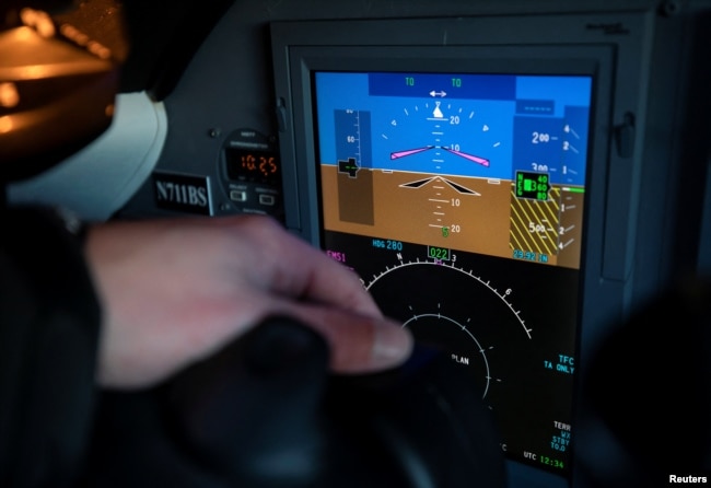 Robert Bryan, chief pilot at Eagle Aviation, points to a displayed altimeter reading while discussing the effect that new 5G wireless services can have on sensitive airplane electronics.