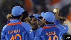 India's Harbhajan Singh (2nd L) is congratulated by teammates Yuvraj Singh (L), Virender Sehwag (C), captain and wicketkeeper Mahendra Singh Dhoni and Suresh Raina (R) after taking the wicket of Pakistan's captain Shahid Afridi during their ICC Cricket Wo