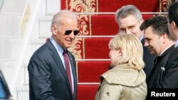 U.S. Vice President Joe Biden (L) shakes hands with Ukrainian and U.S. officials upon his arrival at Boryspil International airport outside Kiev April 21, 2014. Biden will announce a package of technical assistance focused on energy and economic aid distr