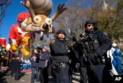 Heavily-armed members of the New York Police Department take a position along the route before the start of the Macy's Thanksgiving Day Parade in New York, Nov. 23, 2017.