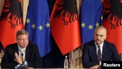FILE - European Union Enlargement Commissioner Stefan Fuele (L) attends a news conference with Albania's Prime Minister Edi Rama, in Tirana, Albania, June 4, 2014.