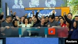 Facebook Founder and CEO Mark Zuckerberg, shown in this image from Reuters video, rings the NASDAQ Stock Market Opening Bell remotely from "Facebook" headquarters in Menlo Park, California, May18, 2012.