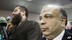 Saad el-Katatni, secretary general for the Muslim Brotherhood's Freedom and Justice Party, right, attends a press conference in Cairo, Egypt, Jan. 16, 2012.