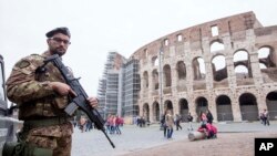 FILE - A soldier is seen on patrol in front of the Colosseum in Rome, Nov. 14, 2015. Italy increased its security measures following the November 13 Paris terror attacks.