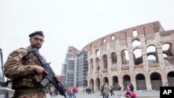 FILE - A soldier is seen on patrol in front of the Colosseum in Rome, Nov. 14, 2015. Italy increased its security measures following the November 13 Paris terror attacks.