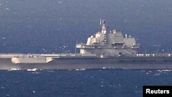 FILE - China's aircraft carrier Liaoning sails the water in East China Sea.