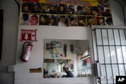 Haitian immigrant Kenson is pictured inside his barbershop in Tijuana, Mexico, Nov. 22, 2018.