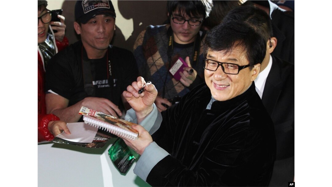 FILE - Martial arts star Jackie Chan says he's ashamed of his son, indicted on a drug charge. Here, the elder Chan signs autographs in Seoul, South Korea, Jan. 19, 2014.