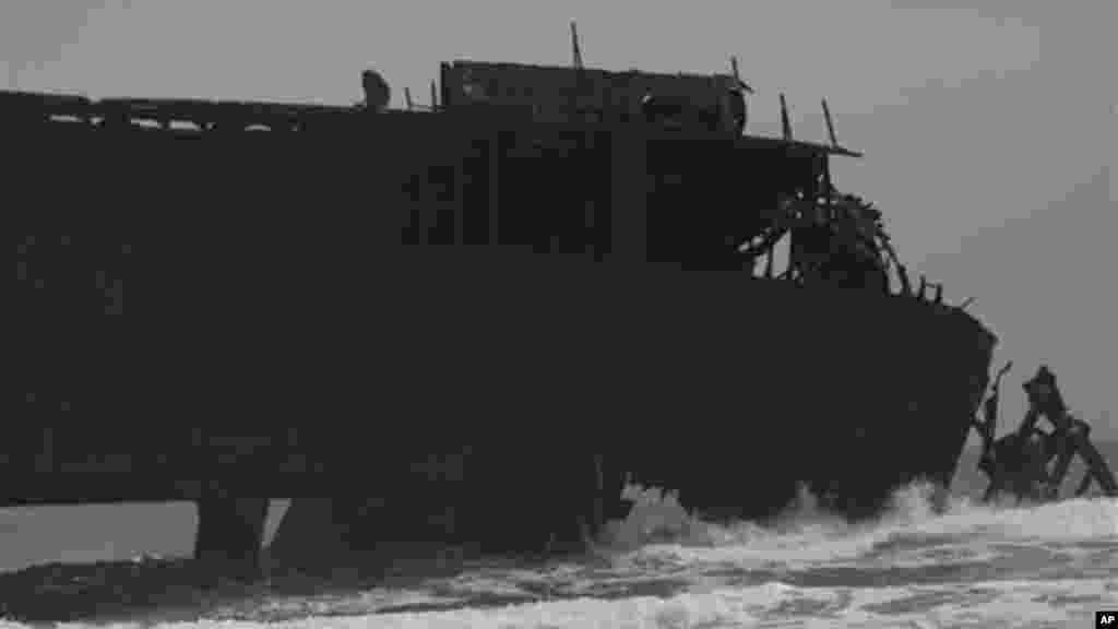 The rusting hulk of an abandoned ship is beached on the coastline of Nigeria.