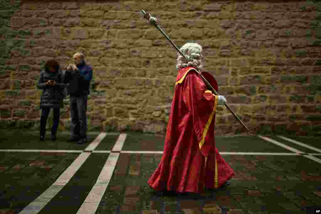 A man dressed in ancient regional costume takes part in a procession in honor of Saint Saturnino, in Pamplona, northern Spain.