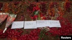 Flowers and notes are pictured on the ground at the entrance of the Army Public School, which was attacked by Taliban gunmen, in Peshawar, Dec. 22, 2014.