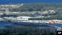 FILE - Navy ships homeported at Naval Station Guam dock at a portion of inner Apra Harbor, seen in this file photo taken May 10, 2005, with the Philippine Sea shown in the background.
