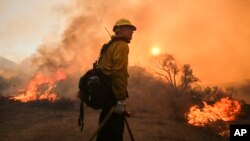 A firefighter watches a wildfire near Placenta Caynon Road in Santa Clarita, California, July 24, 2016. 