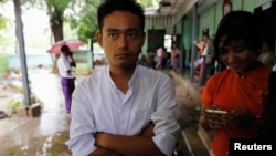 Poet Maung Saung Kha, 23, stands after a court sentenced him to six months in jail for defaming former president Thein Sein, making him one of the first political activists sentenced since Nobel Peace Prize laureate Aung San Suu Kyi took power in Yangon, 