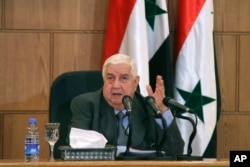 In this photo released by the Syrian official news agency SANA, Syrian Foreign Minister Walid Moallem, speaks during a press conference, in Damascus, Syria, April 6, 2017.