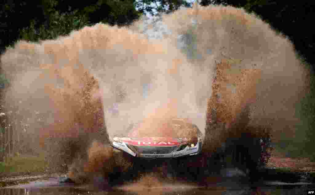 Peugeot&#39;s pilot Sebastien Loeb and co-pilot Daniel Elena, both from France, compete during the 2017 Dakar Rally Stage 1 between Asuncion and Resistencia, in Argentina, Jan. 2, 2017.