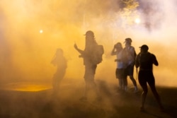 Demonstrators stand in a cloud of tear gas outside the White House on May 30, 2020 in Washington DC, during a protest over the death of George Floyd.