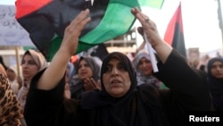 FILE - Women take part in a demonstration against the country's parliament and in support of the coalition of fighters called the Benghazi Revolutionaries Shura Council, at Freedom Square, Benghazi, Aug. 29, 2014.