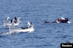 FILE - Migrants are rescued by the Italian Navy in the Mediterranean Sea, in this picture released on Jan. 28, 2016 by Italian Navy.