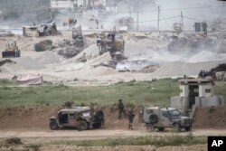 Israeli soldiers are seen near the Gaza border, March 28, 2018.