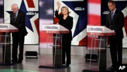 FILE - Hillary Clinton waves as Bernie Sanders, left, and Martin O'Malley prepare before a Democratic presidential primary debate, Nov. 14, 2015, in Des Moines, Iowa.