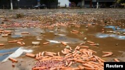 Fruits and vegetables lay on a muddy ground after heavy rain caused flooding in Franco da Rocha, Sao Paulo State, Brazil, Jan. 31, 2022.