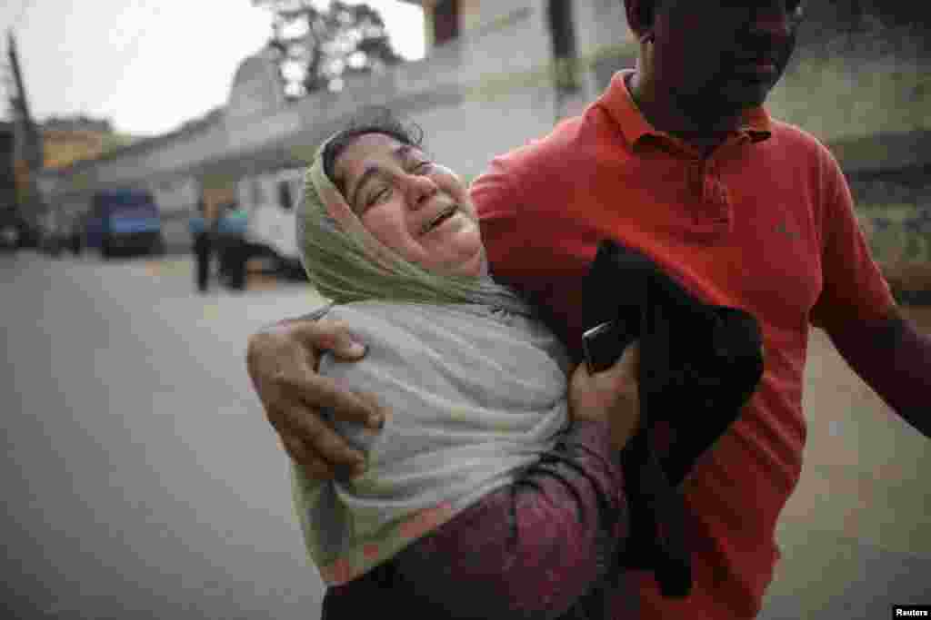 A relative of a prisoner cries after the verdict for a 2009 mutiny was announced, Dhaka, Nov. 5, 2013. 