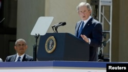 Former U.S. President George W. Bush addresses the dedication of the George W. Bush Presidential Center as U.S. President Barack Obama (L) listens during the ceremony on the campus of Southern Methodist University in Dallas, Texas, April 25, 2013.