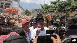 Presiden Joko Widodo (tengah) memberi keterangan kepada media setelah meninjau Roa-Roa Hotel dan daerah yang terdampak gempa bumi dan tsunami di Palu, Sulawesi Tengah, 3 Oktober 2018.