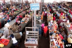 People shop at a market in Luanda, Angola, Jan. 19, 2018. Angolan President Joao Lourenco was elected last year promising an "economic miracle". But the path to transforming the oil-dependent country's system will be long and difficult.