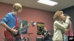 Students at the School of Rock program perform in a band as they receive instruction, March 2011