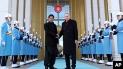 Turkey's President Recep Tayyip Erdogan, right, welcomes Pakistan's Prime Minister Imran Khan to Ankara, Turkey, Friday, Jan. 4, 2019. The two expected to discus bilateral and regional issues.
