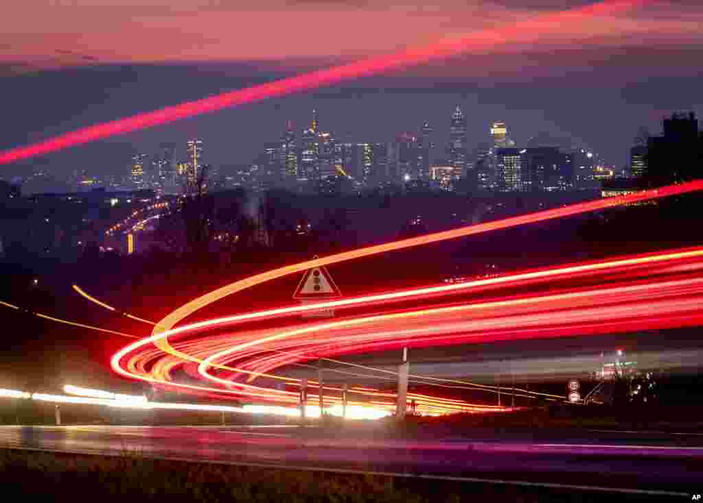 This long exposure picture shows car lights of commuters driving down to the city of Frankfurt, Germany.