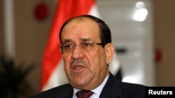 FILE - Iraq's Prime Minister Nuri al-Maliki speaks during an interview with Reuters in Baghdad, Jan. 12, 2014. 