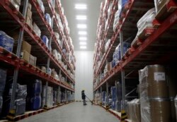 A worker moves boxes at Snowman Logistics, India's largest cold storage company in Taloja, on the outskirts of Mumbai, India, Saturday, Oct. 17, 2020. (AP Photo/Rajanish Kakade)