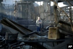 Dick Marsala looks through debris from his destroyed home after a wildfire roared through the Rancho Monserate Country Club Friday, Dec. 8, 2017, in Bonsall, Calif.