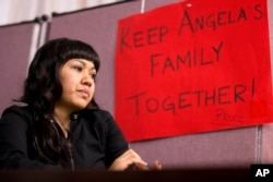 FILE - Angela Navarro, who has been living in the U.S. with her American-born children despite a deportation order issued 10 years ago, sits at the West Kensington Ministry church in Philadelphia, Dec. 8, 2014. Navarro took sanctuary with her children and husband, a U.S. citizen, in the Philadelphia church to help her avoid being deported to her native Honduras.