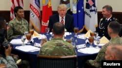 U.S. President Donald Trump attends a lunch with members of the U.S. military during a visit at the U.S. Central Command (CENTCOM) and Special Operations Command (SOCOM) headquarters in Tampa, Florida, U.S., February 6, 2017. REUTERS/Carlos Barria TPX IMAGES OF THE DAY - RTX2ZWGG