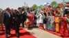 Chinese President Xi Jinping waves to children with Pakistan's Present Mamnoon Hussain, left, at Nur Khan airbase in Islamabad, Pakistan, April 20, 2015.