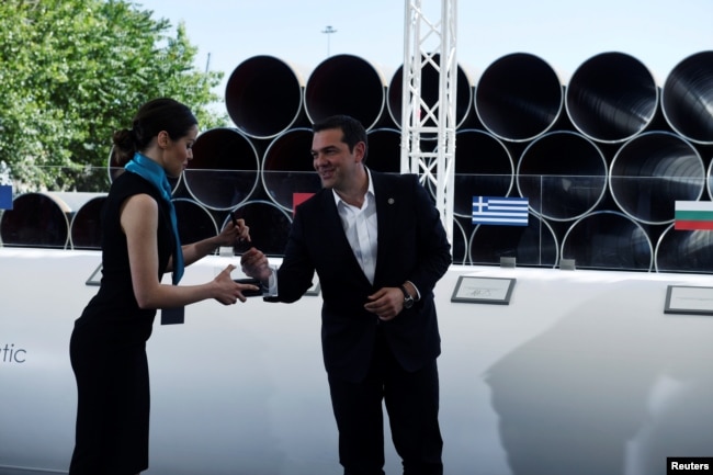 Greece's Prime Minister Alexis Tsipras prepares to sign during the Trans Adriatic Pipeline inauguration ceremony, in the northern Greek city of Thessaloniki, May 17, 2016.