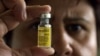 FILE - A bottle containing yellow fever vaccine.