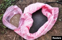 FILE - Poppy seeds are displayed in bags in a field.