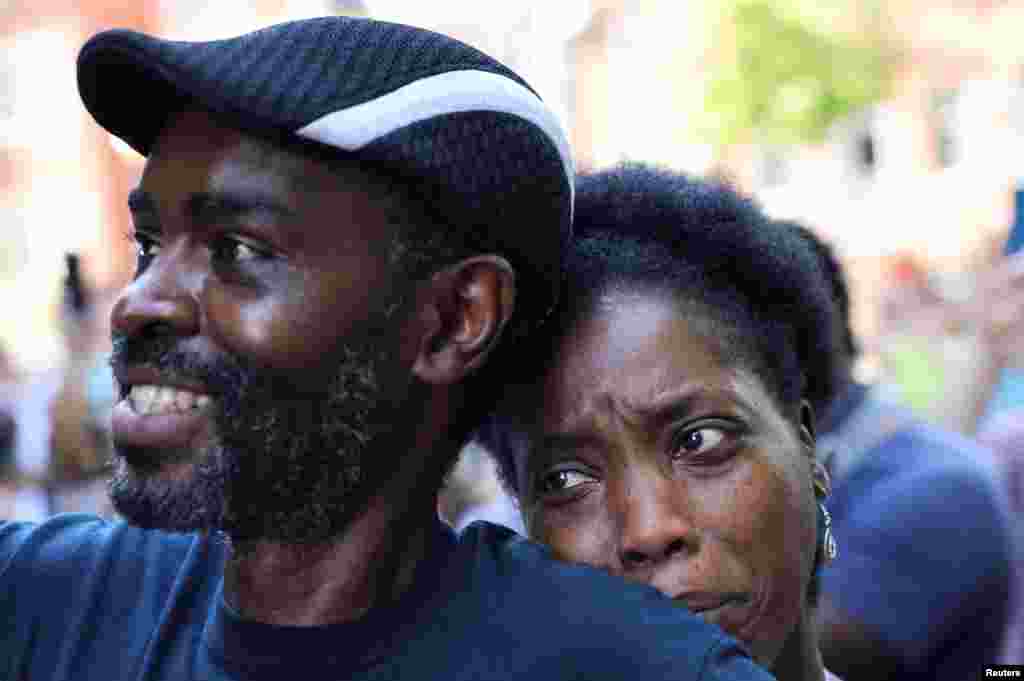 Tanya and Evance Chanda from Mechanicsville look on as a statue of Confederate General Thomas &quot;Stonewall&quot; Jackson is removed after years of a legal battle over the contentious monument, in Charlottesville, Virginia, July 10, 2021.