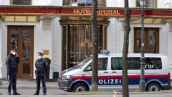 Police officers stand in front of Hotel Imperial where a delegation from Iran is staying in Vienna, Austria, Tuesday, April 6, 2021. (AP Photo/Florian Schroetter)